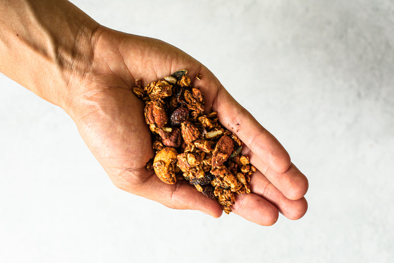 Handful of natural granola, with zero added sugar, packed with nuts. Vegan and gluten-free granola